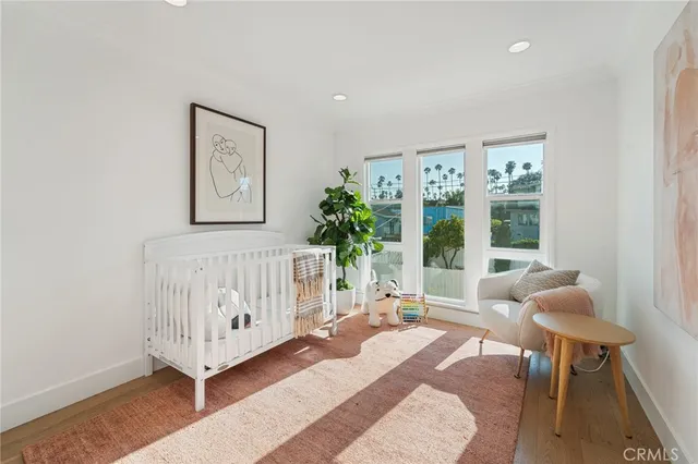 a bedroom with furniture and a large window