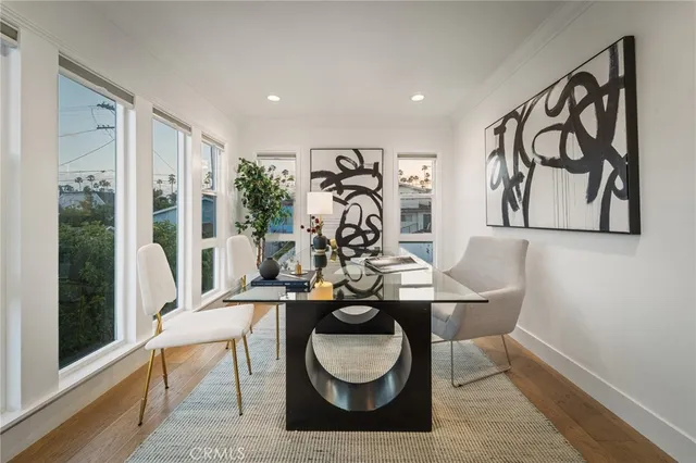 a view of a livingroom with furniture and hallway