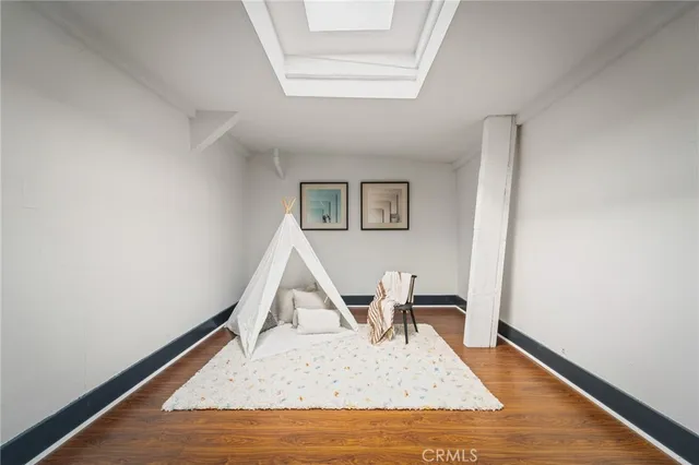 a view of a livingroom with wooden floor and a cabinet
