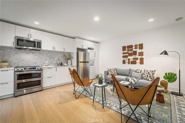a living room with furniture and kitchen view