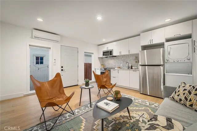 a living room with furniture and kitchen view