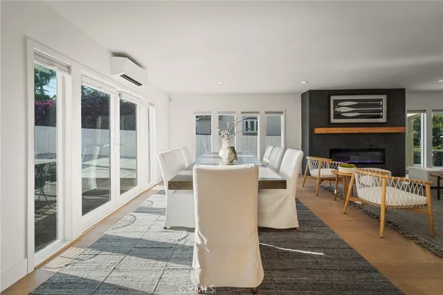 a living room with furniture a large window and a fireplace