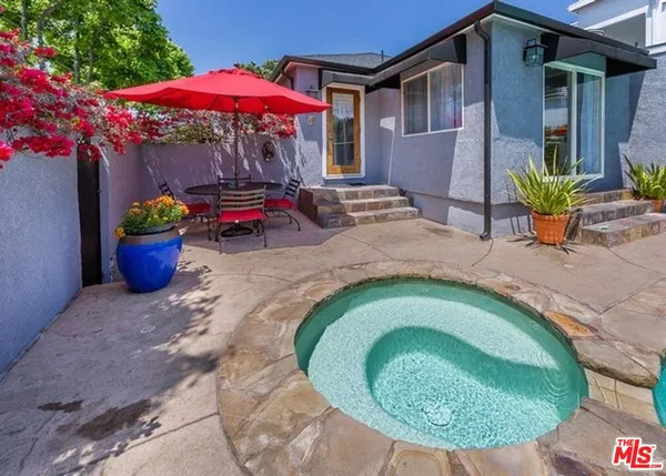 an outdoor space with furniture and umbrella