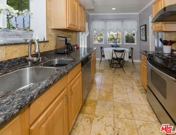 a kitchen with stainless steel appliances granite countertop a sink and a counter