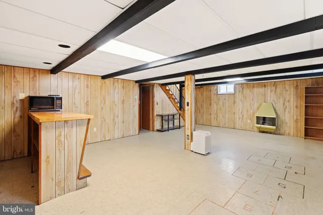 a view of a livingroom with furniture and a window