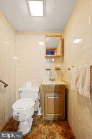 a bathroom with a toilet sink and mirror