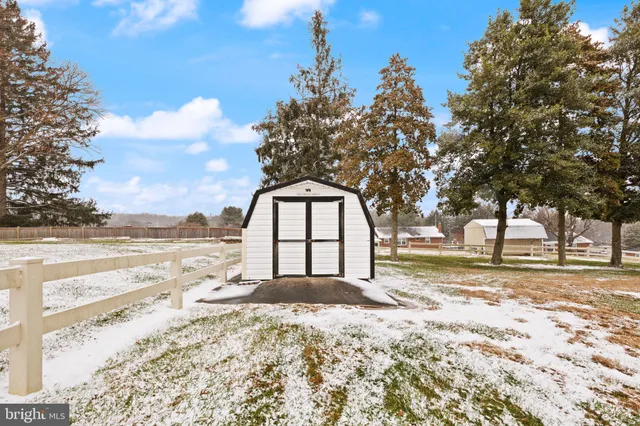 a large tree in front of a house with a yard
