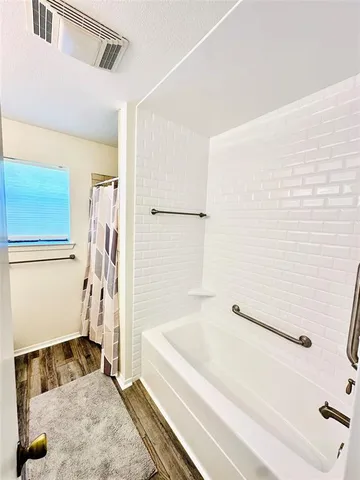 a bathroom with a bathtub and a shower