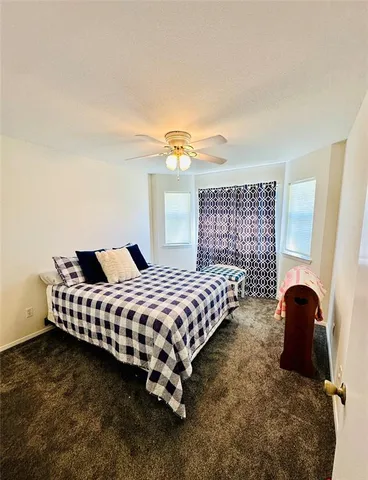 a bedroom with a bed and window