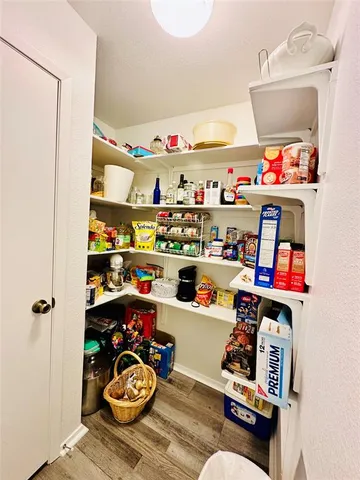 a room with furniture a rug toys and dresser