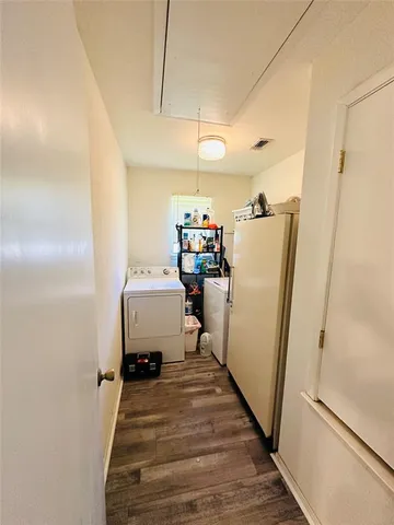 a view of a hallway with furniture and a window