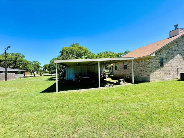 a view of a house with a yard and sitting area