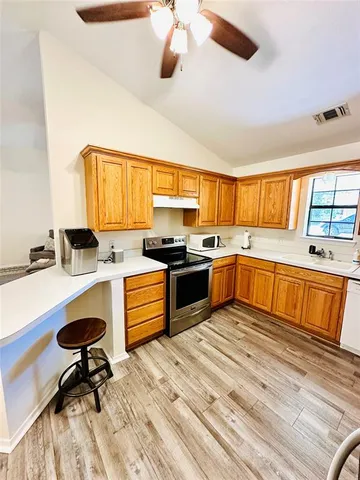 a kitchen with a stove a sink and a refrigerator