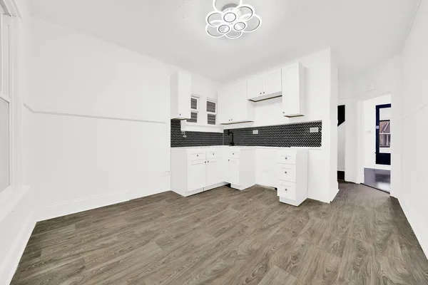 a view of a kitchen with wooden floor