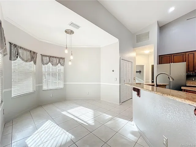 a kitchen with a stove sink and cabinets