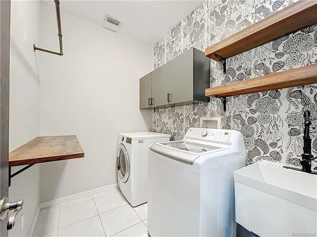 a view of a room with wooden floor and a ceiling fan