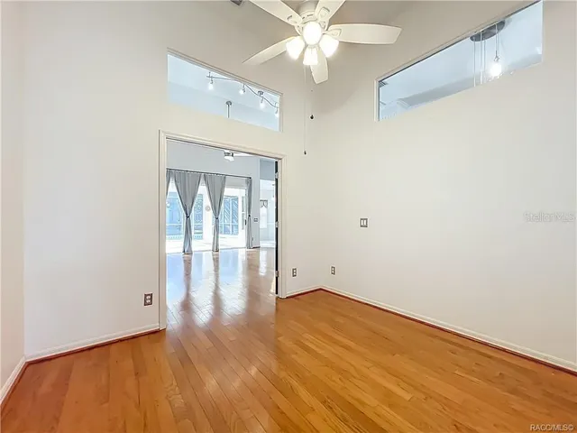 a view of a livingroom with a ceiling fan and window