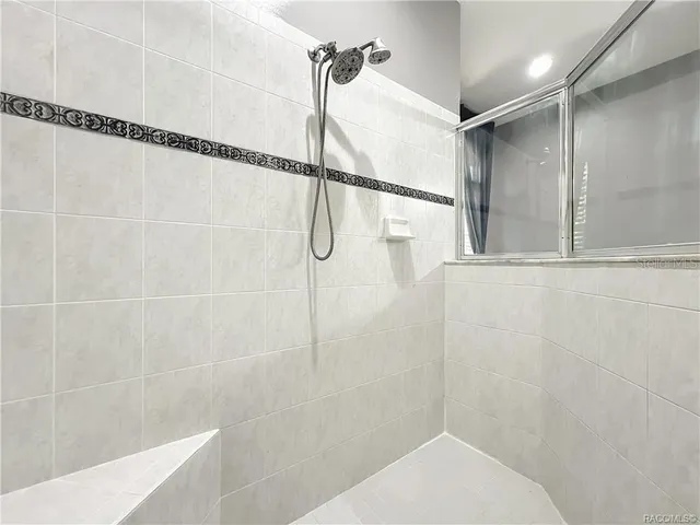 a bath room with a granite countertop sink and a mirror