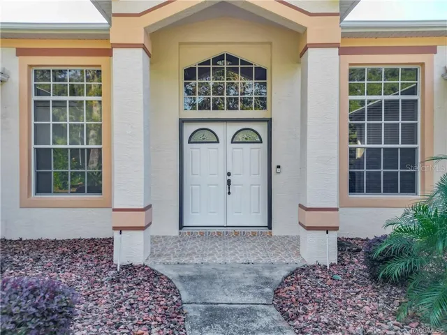 a front view of a house with large windows