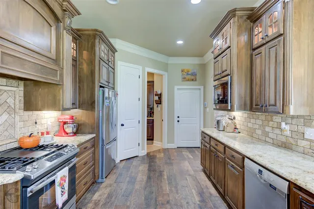 a kitchen with stainless steel appliances granite countertop a stove and a sink