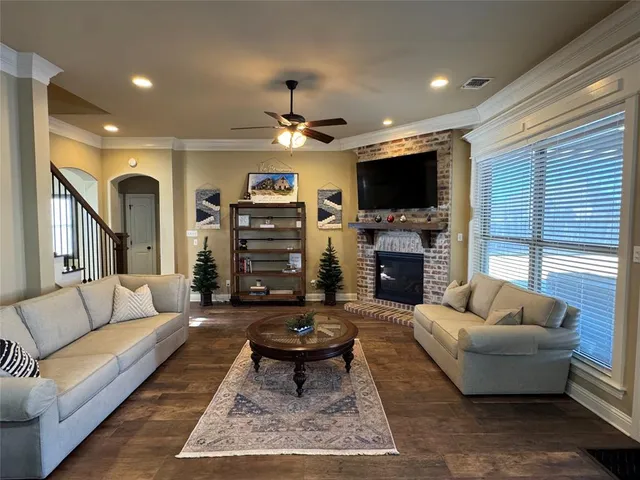 a living room with furniture a flat screen tv and a fireplace