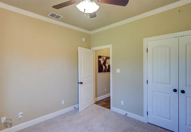 a living room with furniture and a ceiling fan