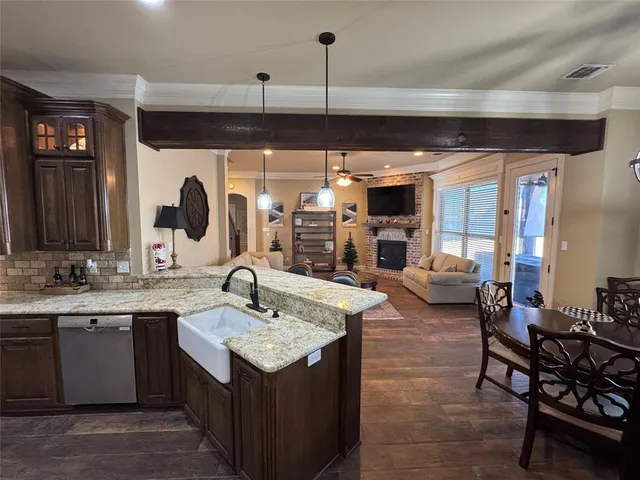 a bathroom with a granite countertop sink toilet and mirror