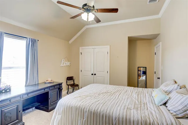 an empty room with closet and chandelier fan