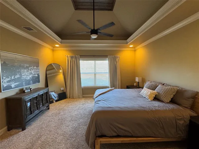 a bedroom with a bed a dresser and a window