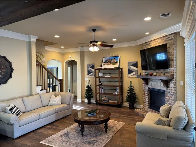 a living room with fireplace furniture and a flat screen tv
