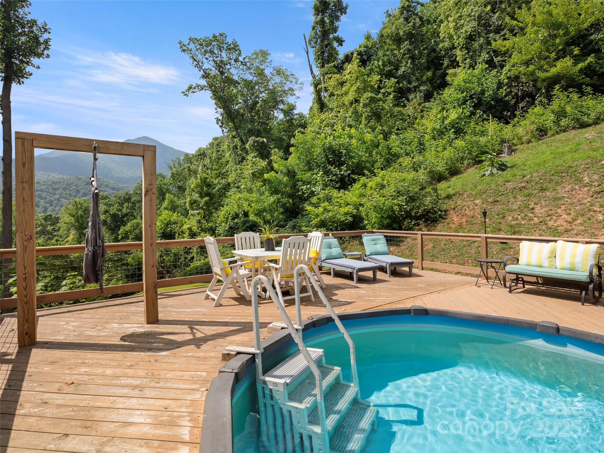 44 Sutton Knob Road Candler, NC 28715 - Photo 12 of 41 a view of a swimming pool with a patio