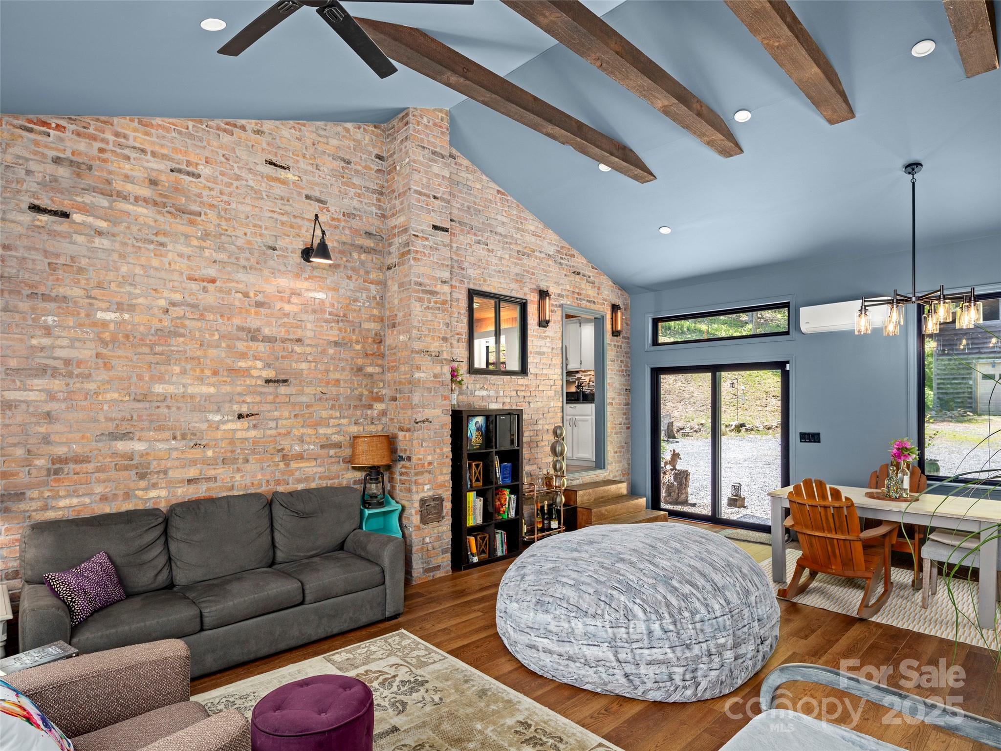 44 Sutton Knob Road Candler, NC 28715 - Photo 15 of 41 a living room with furniture a fireplace and a chandelier