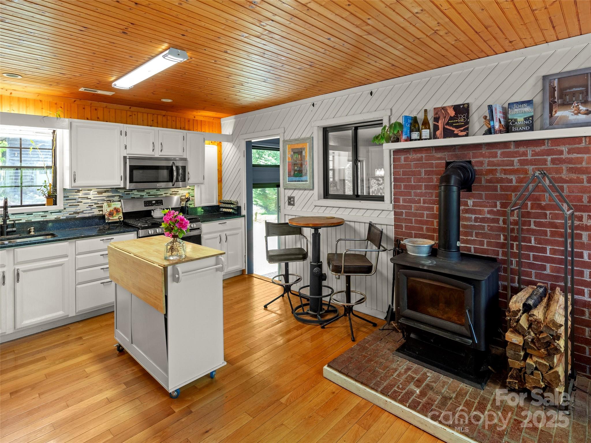 44 Sutton Knob Road Candler, NC 28715 - Photo 16 of 41 a kitchen with microwave a stove and furniture