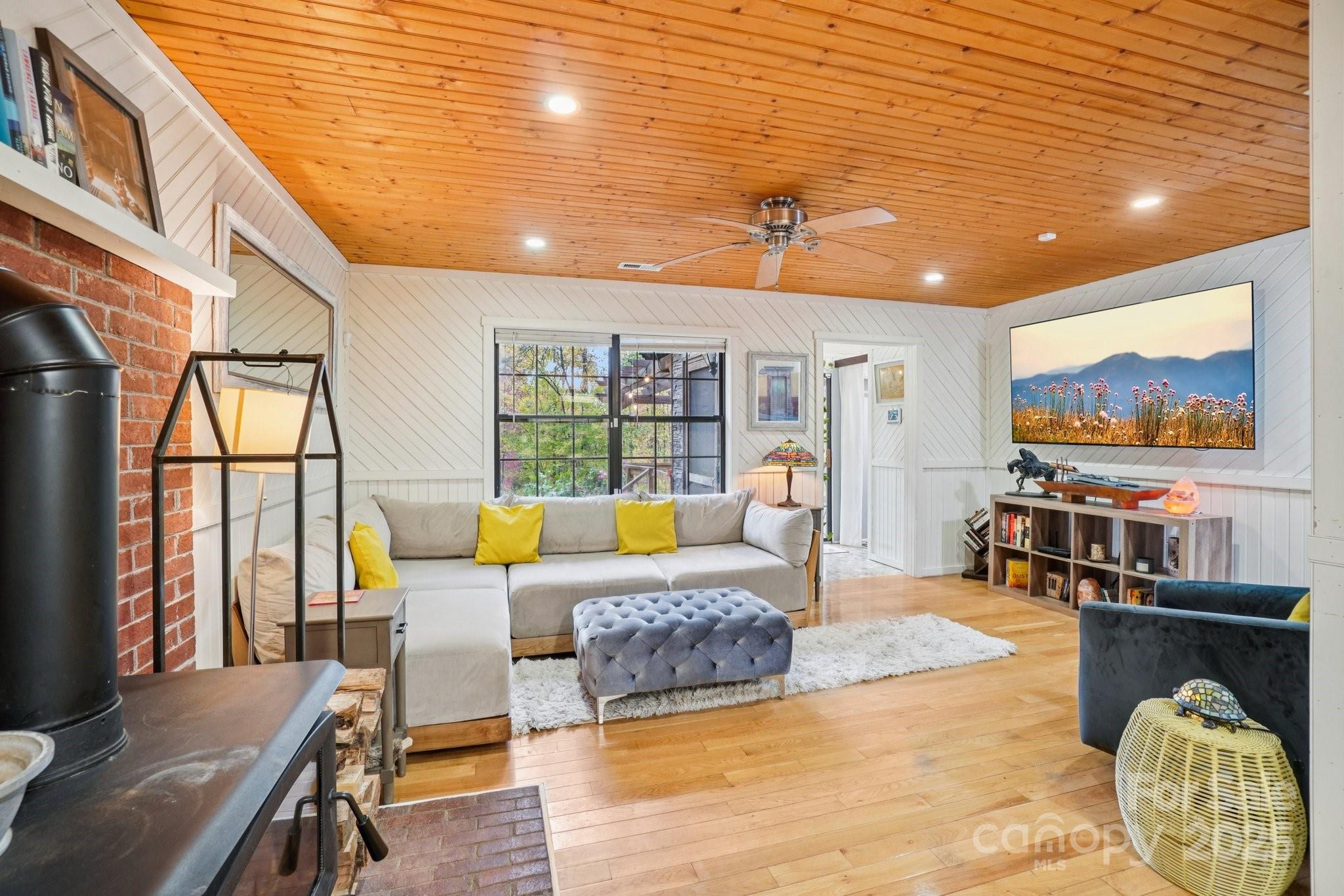 44 Sutton Knob Road Candler, NC 28715 - Photo 17 of 41 a living room with furniture and a floor to ceiling window