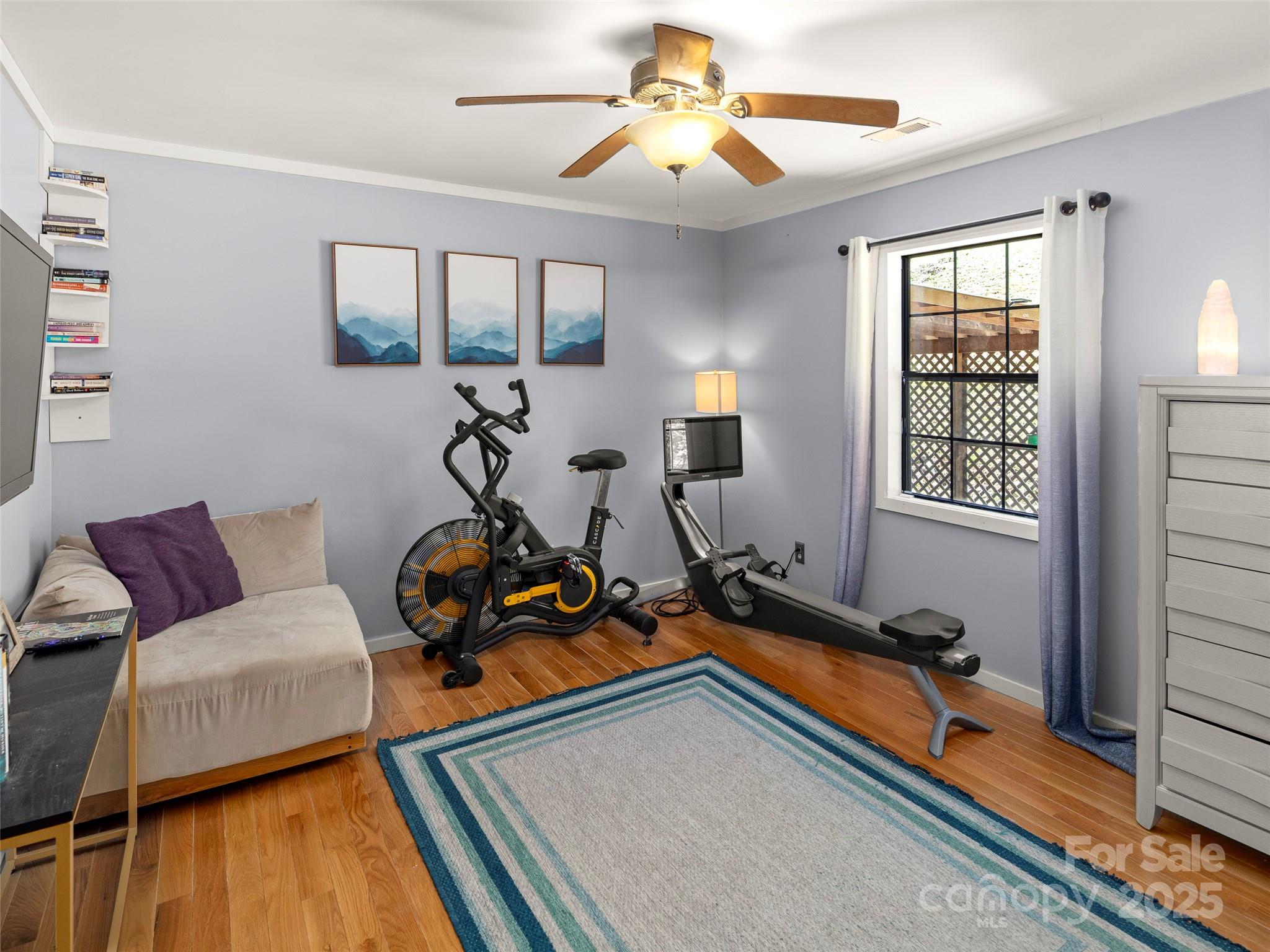 44 Sutton Knob Road Candler, NC 28715 - Photo 19 of 41 a living room with furniture a window and gym equipment