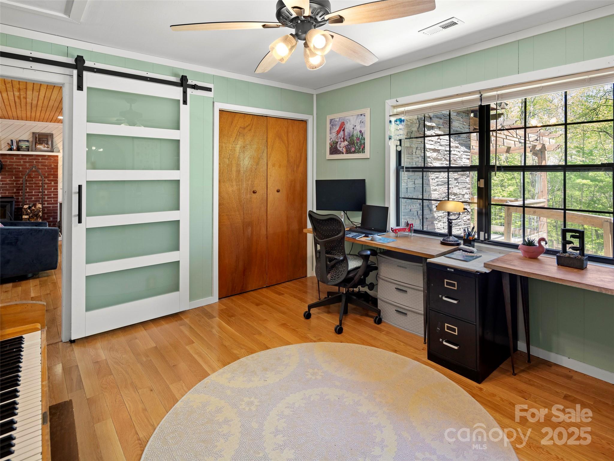 44 Sutton Knob Road Candler, NC 28715 - Photo 21 of 41 a view of a workspace with furniture and a window