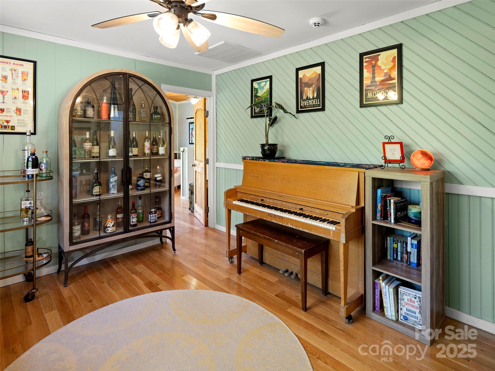44 Sutton Knob Road Candler, NC 28715 - Photo 22 of 41 a room with bookshelf and wooden floor