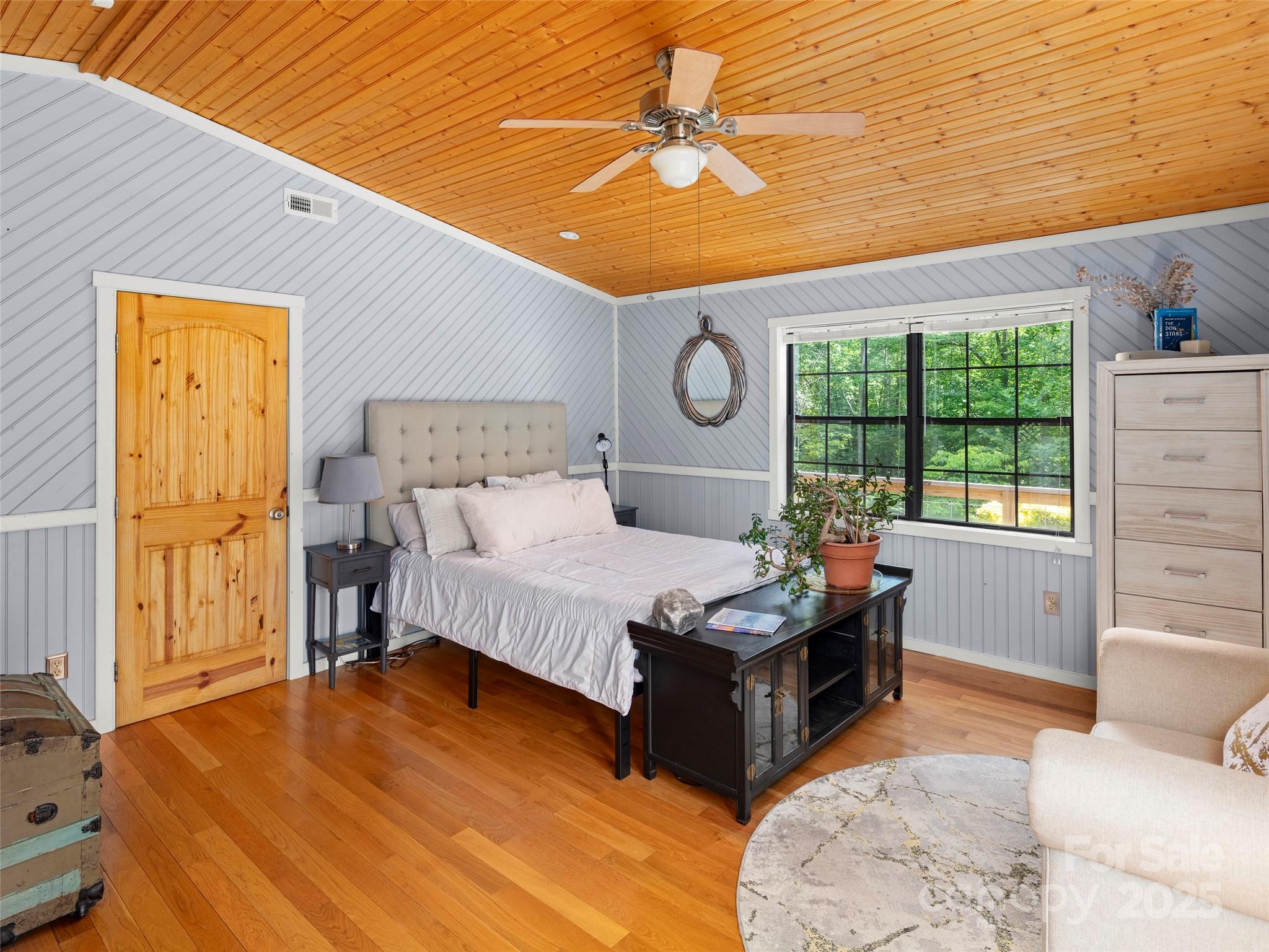 44 Sutton Knob Road Candler, NC 28715 - Photo 23 of 41 a bedroom with a bed and wooden floor