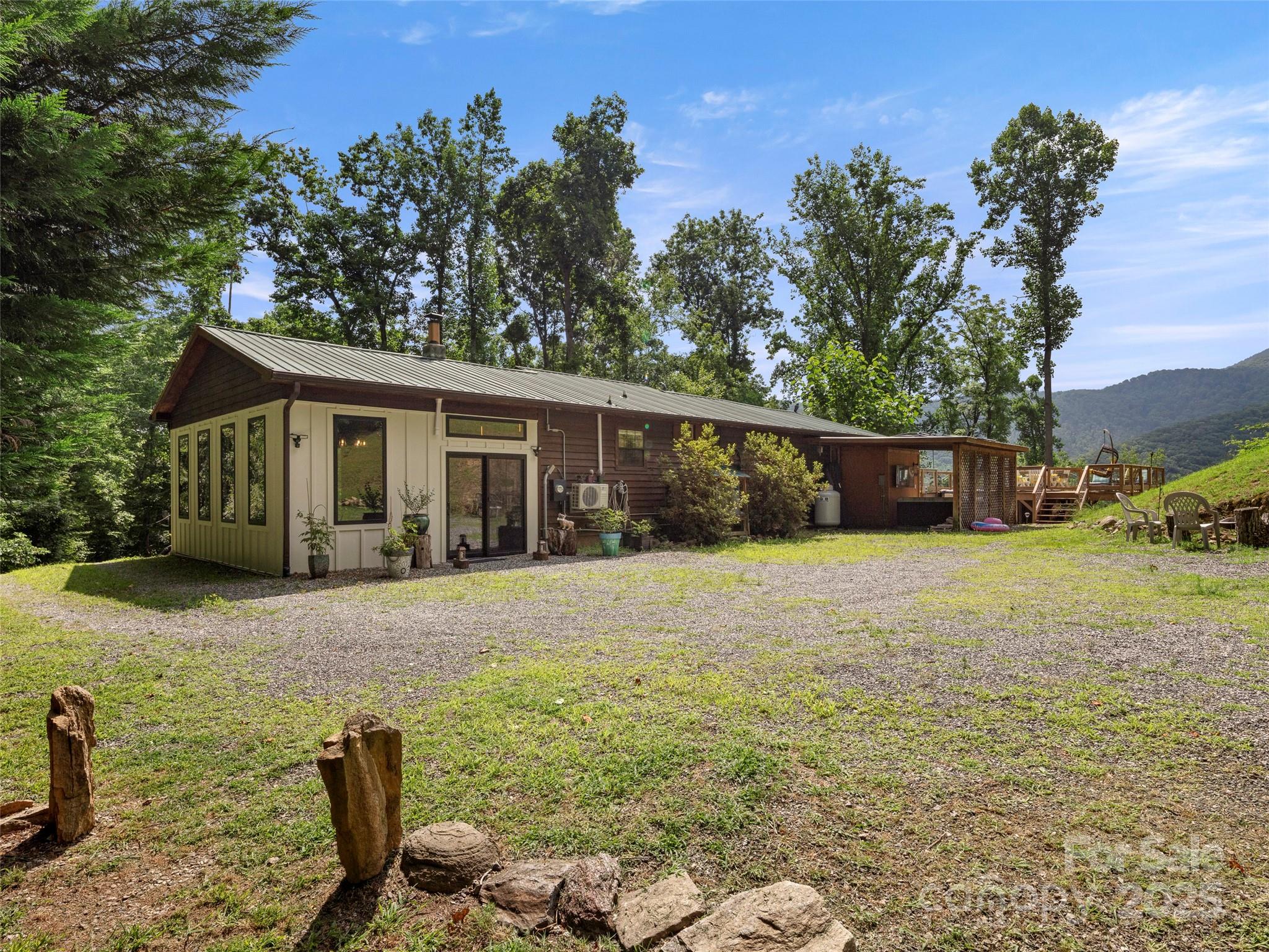 44 Sutton Knob Road Candler, NC 28715 - Photo 30 of 41 a backyard of a house with table and chairs