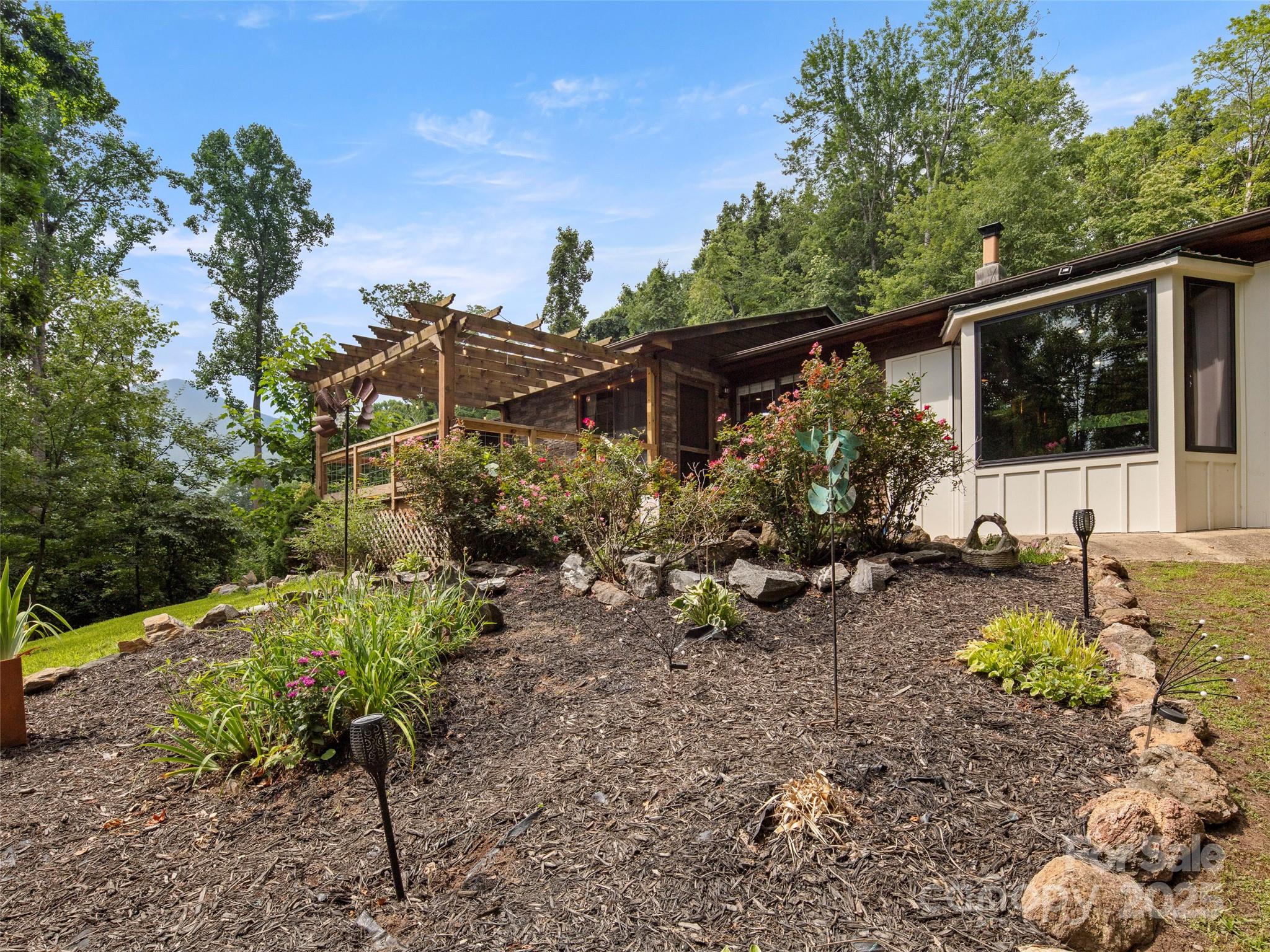 44 Sutton Knob Road Candler, NC 28715 - Photo 34 of 41 a view of a backyard with garden and patio