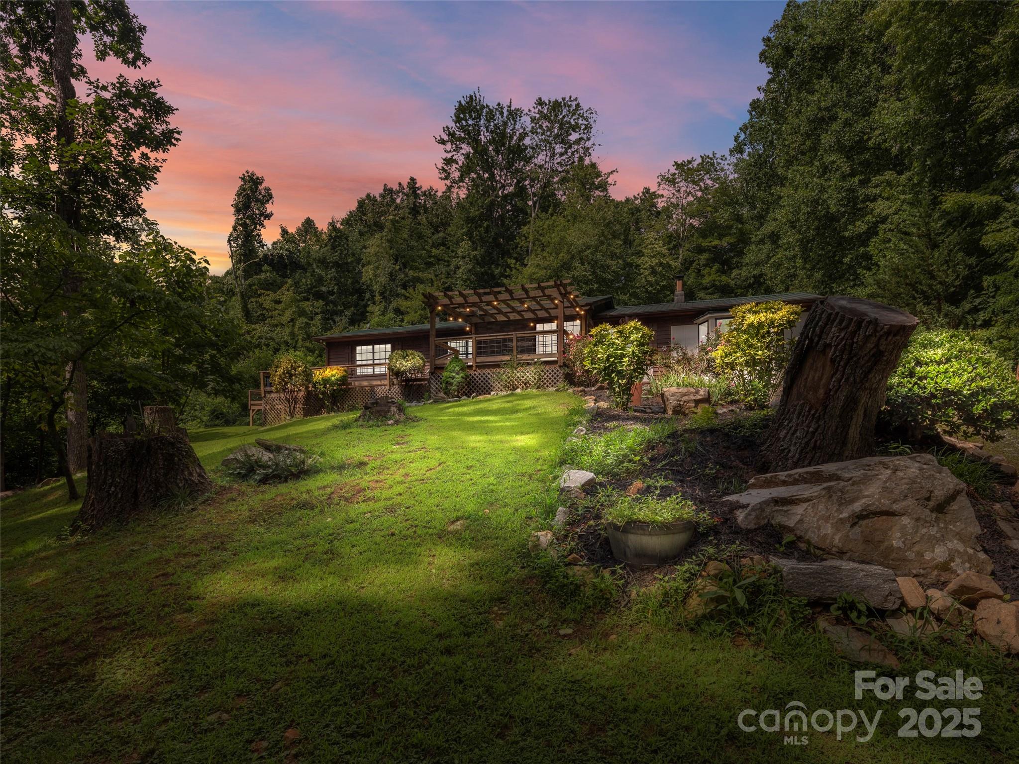 44 Sutton Knob Road Candler, NC 28715 - Photo 41 of 41 a backyard of a house with table and chairs