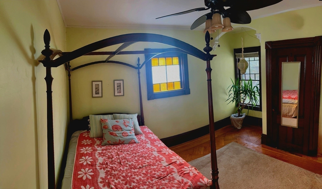 58 Oak Street Boston, MA 02136 - Photo 19 of 26 a bedroom with a bed and a chandelier