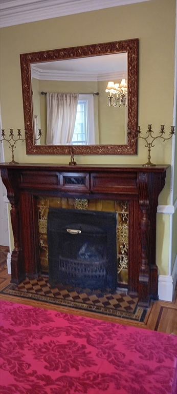 58 Oak Street Boston, MA 02136 - Photo 10 of 26 a fireplace with a clock on top of it