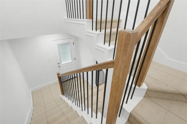 a view of staircase with white walls and a window