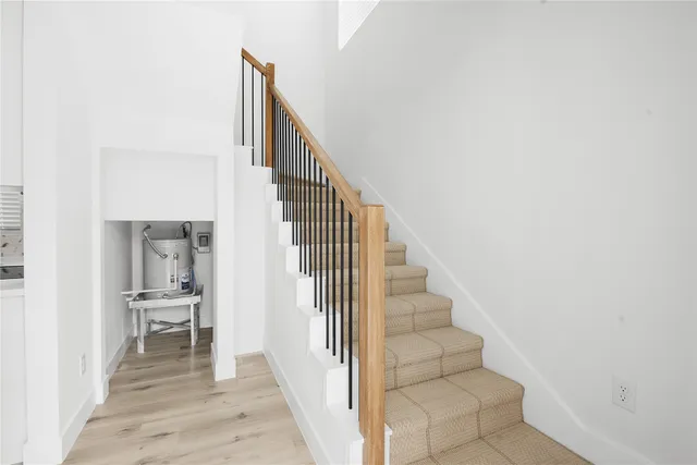 a view of a hallway with wooden floor and entryway