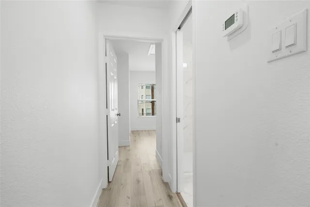 a view of a room with wooden floor