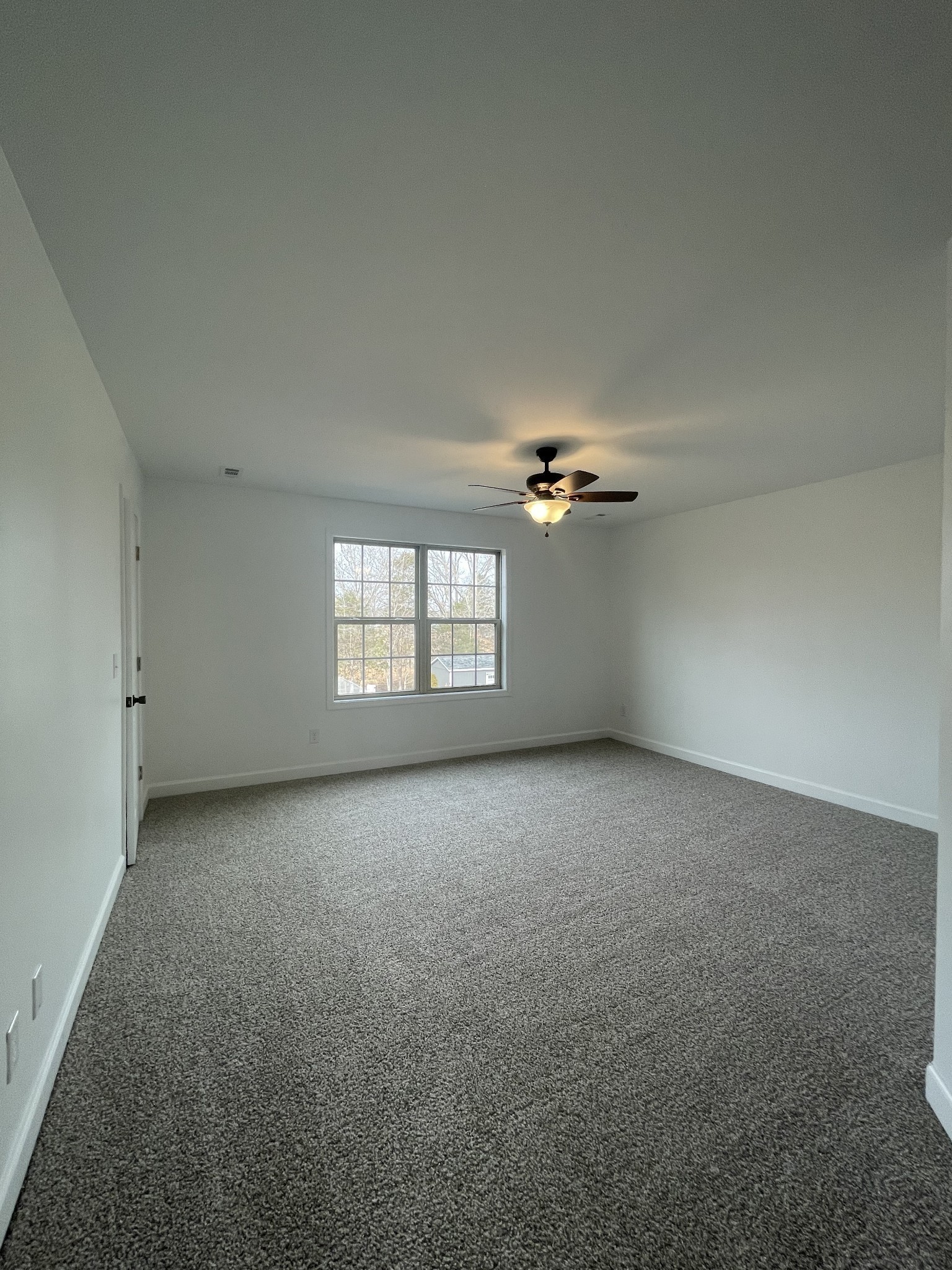 1501 Trainer Road Clarksville, TN 37042 - Photo 15 of 19 an empty room with a ceiling fan and windows