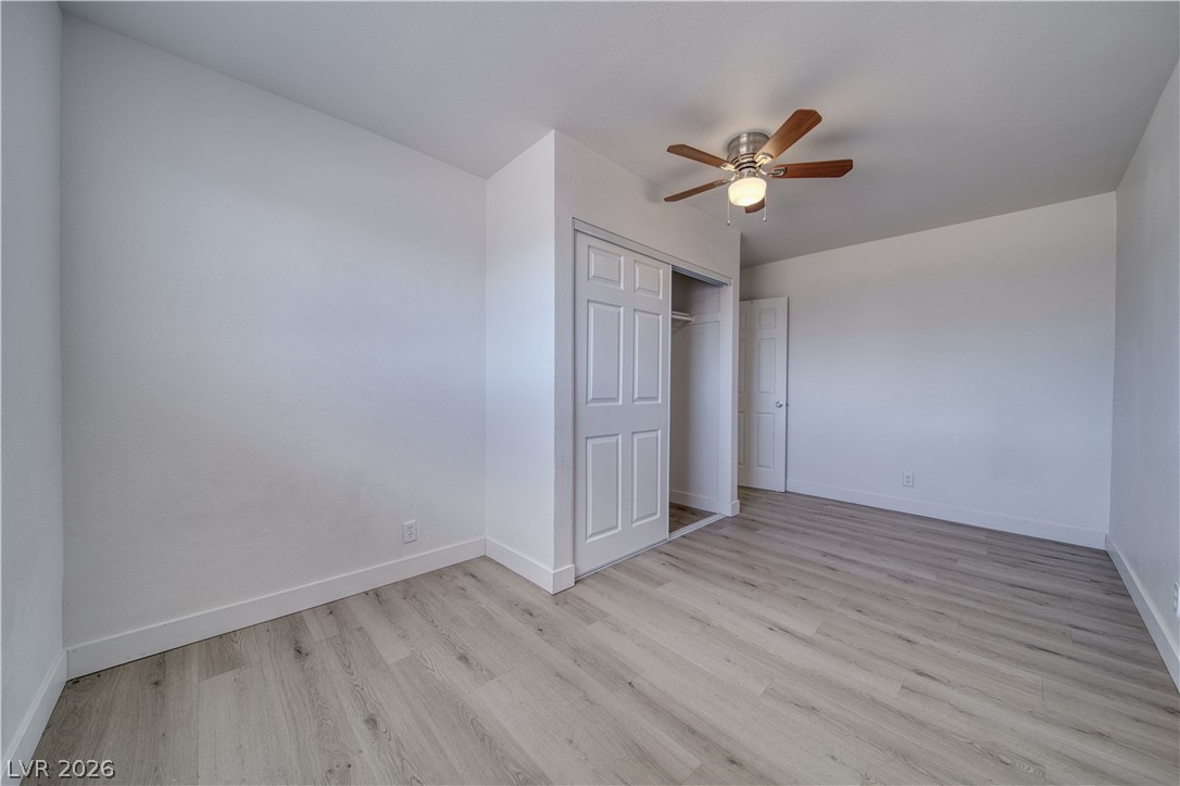 851 Lone Pine Road Pahrump, NV 89048 - Photo 15 of 25 This spacious bedroom offers serene comfort with practical built-in storage and sleek flooring.