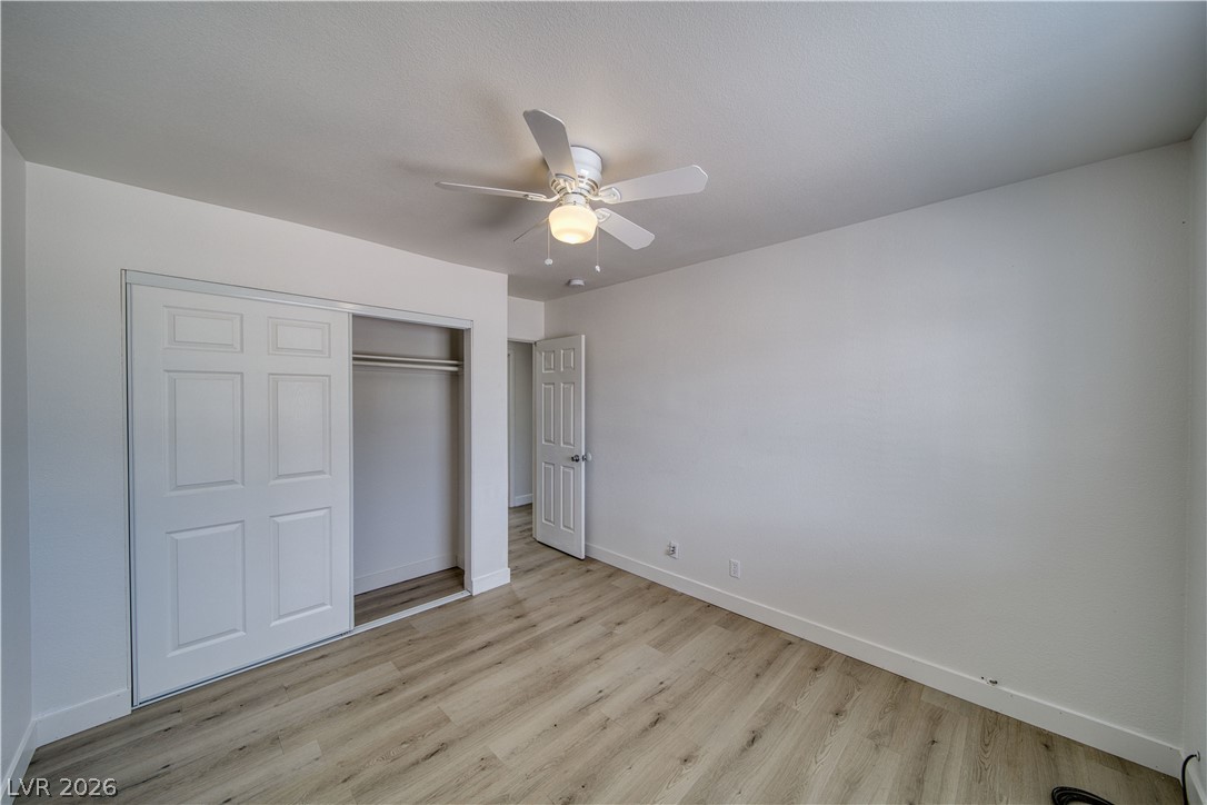 851 Lone Pine Road Pahrump, NV 89048 - Photo 18 of 25 This spacious bedroom offers ample natural light and durable flooring, ideal for comfortable living.