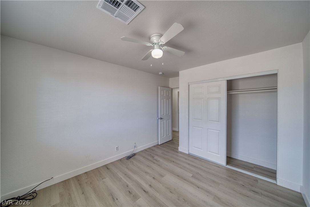 851 Lone Pine Road Pahrump, NV 89048 - Photo 20 of 25 This spacious bedroom offers ample natural light and a clean, versatile design.
